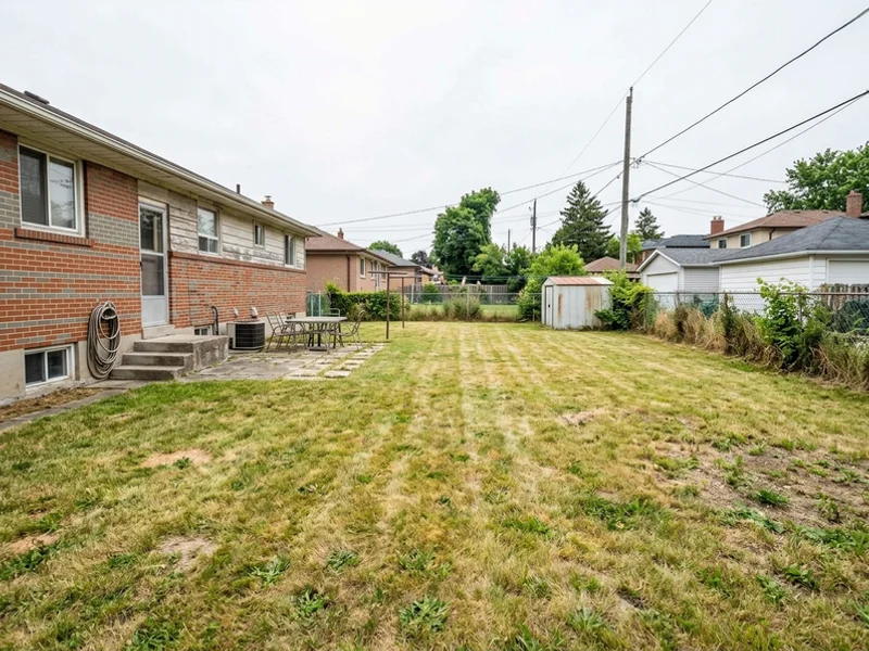 Before: large flat Scarborough backyard with worn lawn